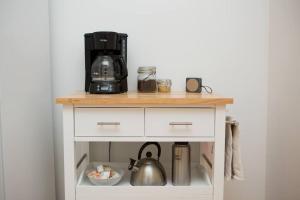 a white cabinet with a coffee maker on top of it at Object Hotel 1BR Shared Bath Room 2C in Bisbee