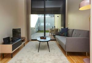 a living room with a couch and a table at ChillHouse_Porto - Praça da República in Porto
