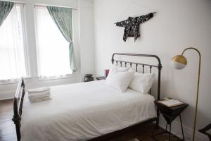 a bedroom with a white bed with a star on the wall at Object Hotel 1BR Shared Bath Room 2D in Bisbee