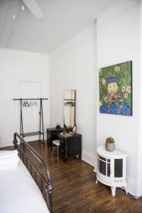 a bedroom with a bed and a painting on the wall at Object Hotel 1BR Shared Bath Room 2D in Bisbee