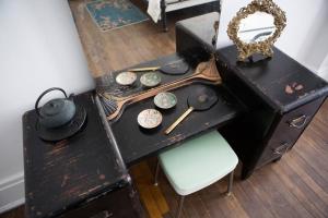 an old black desk with a hat and a chair at Object Hotel 1BR Shared Bath Room 2D in Bisbee +19 photos