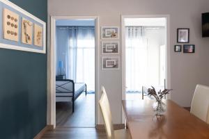 a dining room with a table and a chair at Sarafos Apartment Stavros Rooms in Stavros