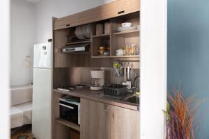 a small kitchen with a sink and a refrigerator at Sarafos Apartment Stavros Rooms in Stavros