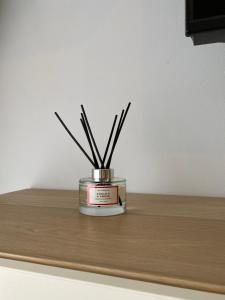 a candleholder with sticks in it sitting on a table at Lemos Mar in Monforte de Lemos