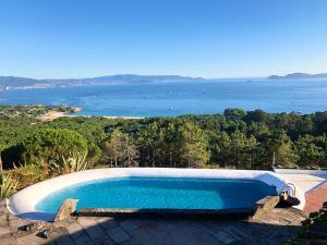 a swimming pool with a view of the water at Casa Fenteiras in Cangas de Morrazo