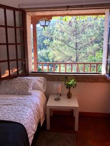 a bedroom with a bed and a large window at Casa Fenteiras in Cangas de Morrazo +73 photos