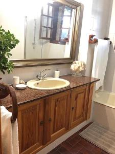 a bathroom with a sink and a mirror and a tub at Casa Fenteiras in Cangas de Morrazo