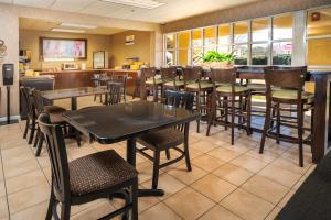 a dining room with tables and chairs in a restaurant at Days Inn by Wyndham Atlanta Stone Mountain in Stone Mountain