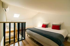 カンヌにあるFlorella Achard Apartmentのベッドルーム1室(大型ベッド1台、赤い枕付)