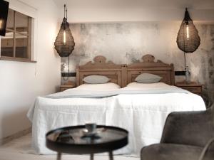a bedroom with a bed with a table in front of it at Berg-Leben in Grossarl +80 photos
