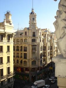 a large building with cars parked in front of it at Hostal Avenida in Madrid +34 photos