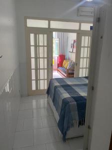 a bedroom with a bed and sliding glass doors at Studio em Copacabana in Rio de Janeiro