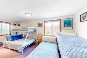 a bedroom with a bunk bed and a bed and a couch at The Hideout in Rockaway Beach