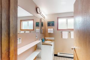 a bathroom with a sink and a mirror at The Hideout in Rockaway Beach +20 photos
