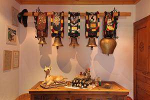 a room with a table with bells on the wall at Lindenhof in Kitzbühel