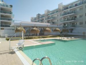 a swimming pool in front of a building at Apartamento Duna Beach in Torrox