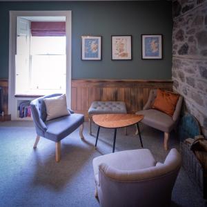 a living room filled with furniture and a window at Craigellachie Lodge in Craigellachie
