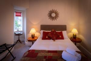a bedroom with a bed and a lamp at Craigellachie Lodge in Craigellachie