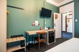 a room with a desk with a chair and a bed at Nightcap at Pymble Hotel in Pymble