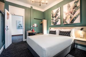 A bed or beds in a room at Nightcap at Pymble Hotel