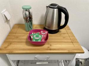 a table with a coffee pot and a container on it at Cosy Apartment in City 1 in Kassel