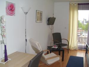a living room with a table and chairs and a television at Casa Rose in Essen