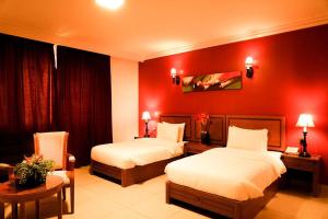 Ένα ή περισσότερα κρεβάτια σε δωμάτιο στο La Rosa Hotel By Brother International