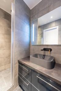 a bathroom with a sink and a mirror at Beaubois in Paris