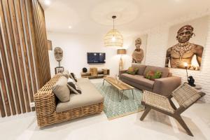 a living room with a large statue of a man at Out of Africa in Paris