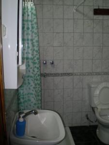 a small bathroom with a sink and a toilet at Hostel Marino Rosario in Rosario