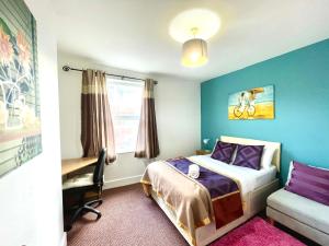 - une chambre avec un lit, une chaise et une fenêtre dans l'établissement 4 bedroomed maisonette in City Centre, near Barbican & Seafront, à Plymouth
