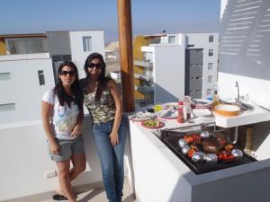 two women standing in front of a kitchen with food at Paracas top tower beach front in Paracas