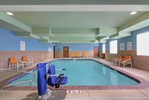 a pool in a hospital room with chairs and tables at Holiday Inn Express Newport, an IHG Hotel in Newport