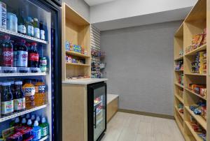 a grocery store aisle with a soda refrigerator at Holiday Inn Express Newport, an IHG Hotel in Newport