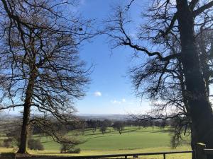 a view of a field with trees and a fence at The Old Kitchen in Burwarton