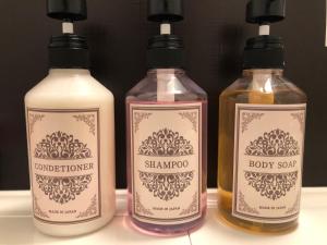 a group of three bottles of soap on a counter at Kyoto Central Inn in Kyoto