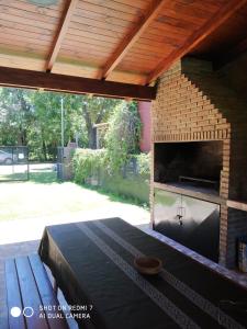 a patio with a brick wall and a fireplace at CASA FUNES in Funes