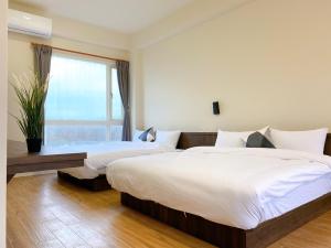 Ein Bett oder Betten in einem Zimmer der Unterkunft 澎湖日記 PenghuDiary