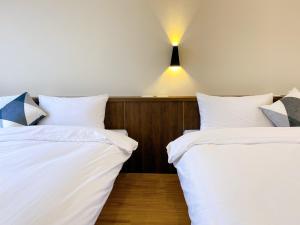 Ein Bett oder Betten in einem Zimmer der Unterkunft 澎湖日記 PenghuDiary