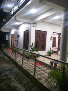 a white building with doors and a fence in front of it at Sushils Bed and Breakfast in Port Blair