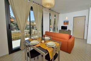 a living room with a table and a couch at Residence Serenella in Diano Marina