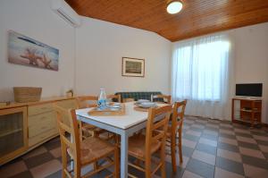 a kitchen and dining room with a table and chairs at Villa Beethoven in Lignano Sabbiadoro