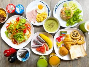a table topped with different types of food at Holiday Inn Express Bangkok Sathorn, an IHG Hotel - SHA Extra Plus Certified in Bangkok