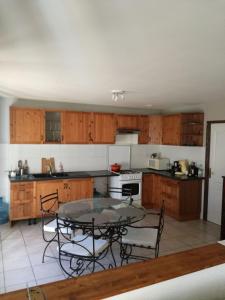 a kitchen with a table and some chairs and a table at Chambre d'Hôtes Spincourt 2 personnes in Spincourt