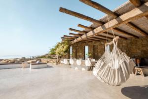 a patio with white bags hanging from the ceiling at Villa Fleur De Sel in Fanari