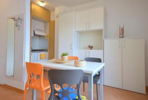 a kitchen with a table and chairs in a room at Residenza Casa Mare in Lignano Sabbiadoro