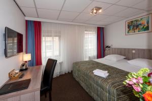 Postel nebo postele na pokoji v ubytování Hampshire Hotel Petit Nord