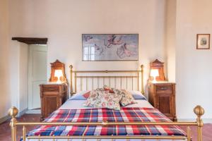 a bedroom with a bed with two night stands at Villa Cenami Apartments with BIG POOL in Massarosa