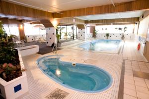 a large swimming pool in a hotel room at The Fredericton Inn in Fredericton