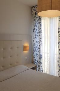a bedroom with a large bed and a window at Albergo Degli Amici in Monterosso al Mare